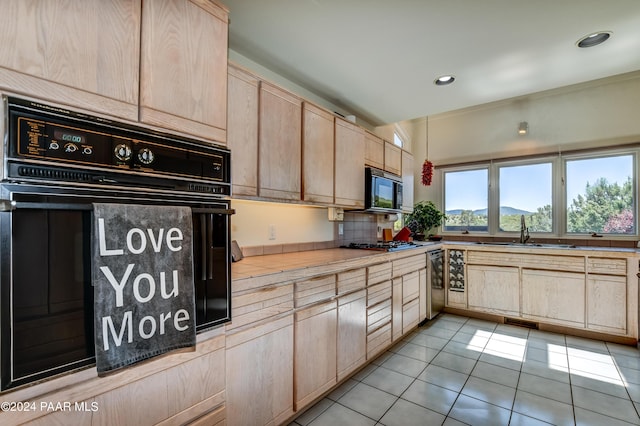 1301 S Manzanita Hill Rd, Prescott, AZ 86303 - kitchen with a sink, light countertops, light brown cabinetry, black appliances, and light tile patterned flooring