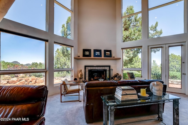 1301 S Manzanita Hill Rd, Prescott, AZ 86303 - carpeted living area featuring a tile fireplace and a high ceiling