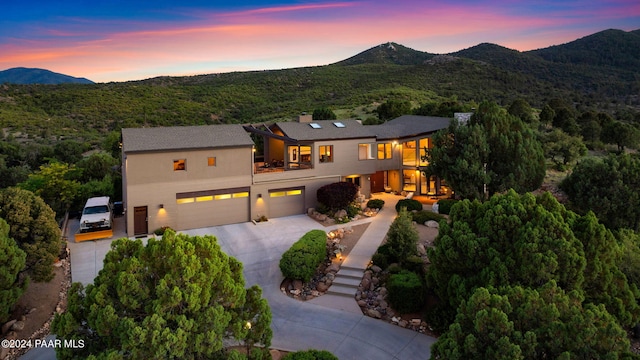1301 S Manzanita Hill Rd, Prescott, AZ 86303 - view of front of home with concrete driveway, a balcony, a chimney, a mountain view, and an attached garage