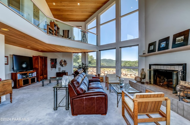 1301 S Manzanita Hill Rd, Prescott, AZ 86303 - carpeted living area featuring a mountain view, a fireplace with raised hearth, wood ceiling, recessed lighting, and a towering ceiling