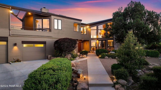 1301 S Manzanita Hill Rd, Prescott, AZ 86303 - contemporary house featuring an attached garage, a chimney, driveway, and a balcony