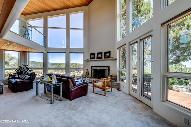 1301 S Manzanita Hill Rd, Prescott, AZ 86303 - living area with carpet, a fireplace with raised hearth, wood ceiling, and a towering ceiling