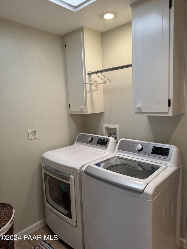 clothes washing area with cabinets and independent washer and dryer