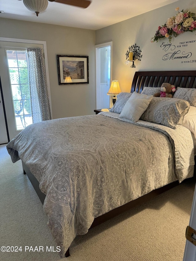 bedroom with access to outside, ceiling fan, and carpet floors