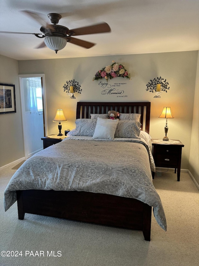 carpeted bedroom featuring ceiling fan