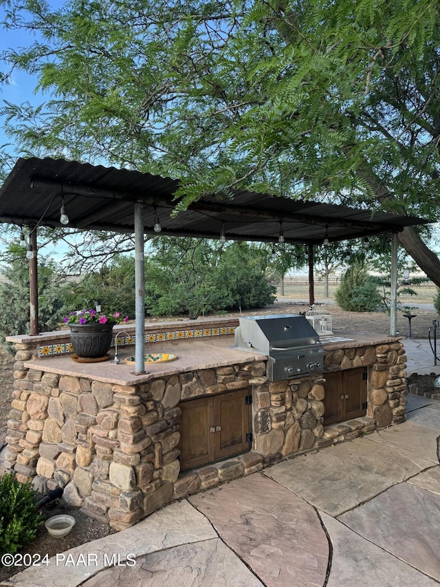 view of patio / terrace featuring area for grilling and exterior kitchen