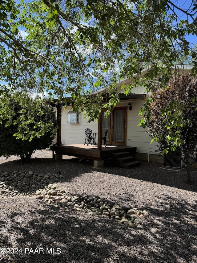 rear view of house with a wooden deck