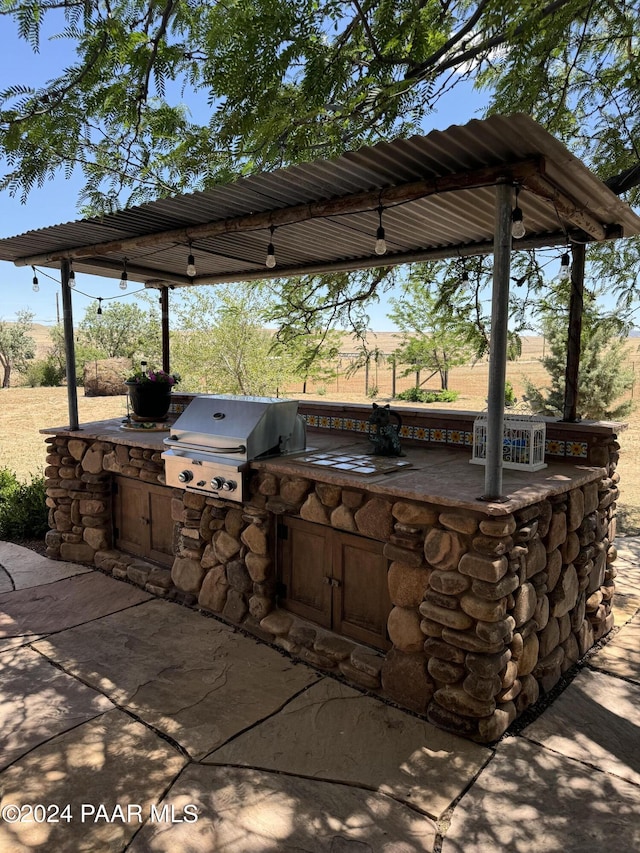 view of patio with area for grilling and exterior kitchen