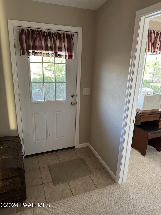 entryway featuring light tile patterned floors