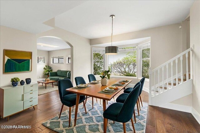 122 N Willow St, Prescott, AZ 86305 - dining space with arched walkways, wood-type flooring, healthy amount of natural light, and stairs