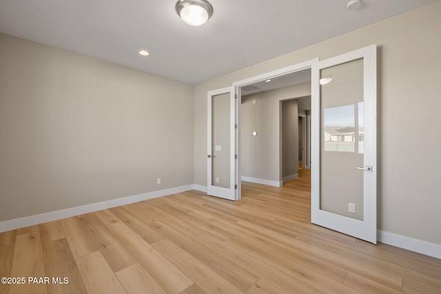 unfurnished room featuring light hardwood / wood-style floors and french doors