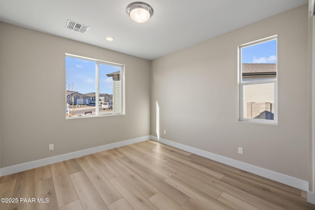 empty room with light hardwood / wood-style flooring