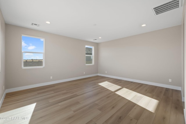 spare room featuring light wood-type flooring