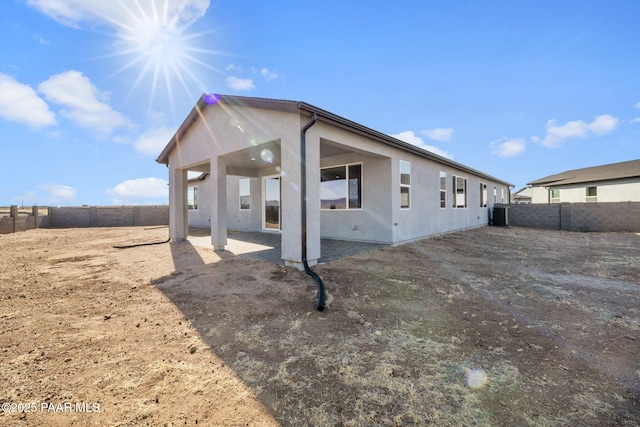 rear view of house featuring cooling unit