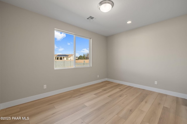 spare room featuring light wood-type flooring