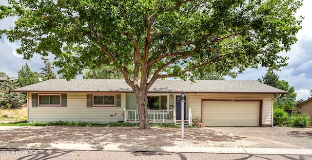 single story home with a garage and covered porch