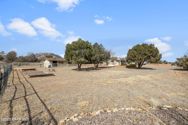 view of yard with a rural view and fence