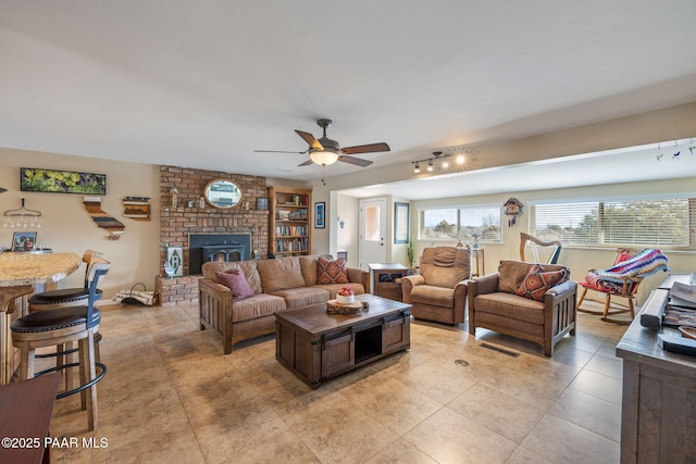 living area with light tile patterned floors and a ceiling fan