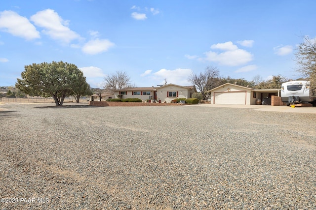 ranch-style house with concrete driveway and a garage