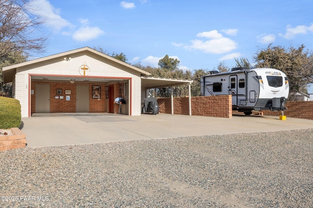 exterior space with a detached garage and fence