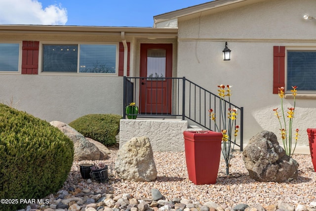 view of exterior entry with stucco siding