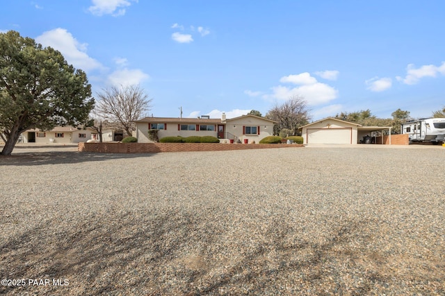 single story home with driveway and an attached garage