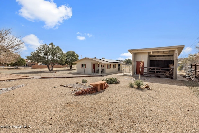 back of property with an exterior structure and an outbuilding