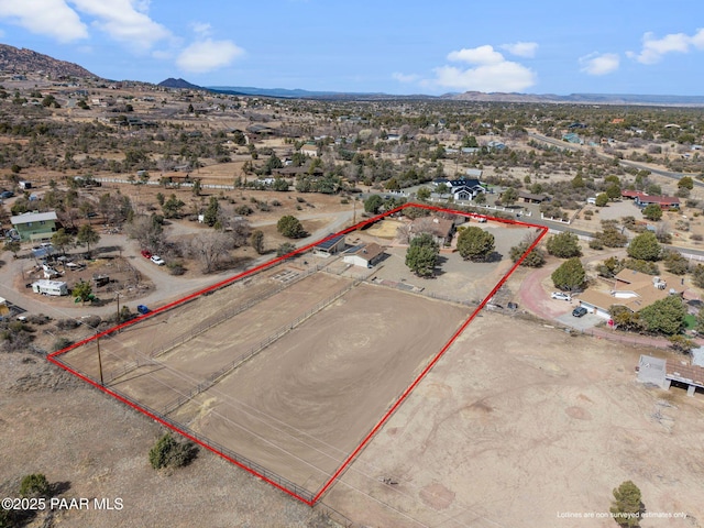 drone / aerial view with view of desert, a rural view, and a mountain view