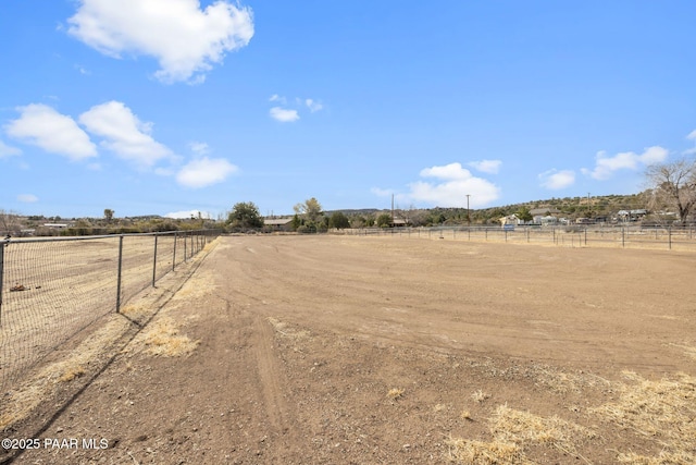 view of road with a rural view and an enclosed area