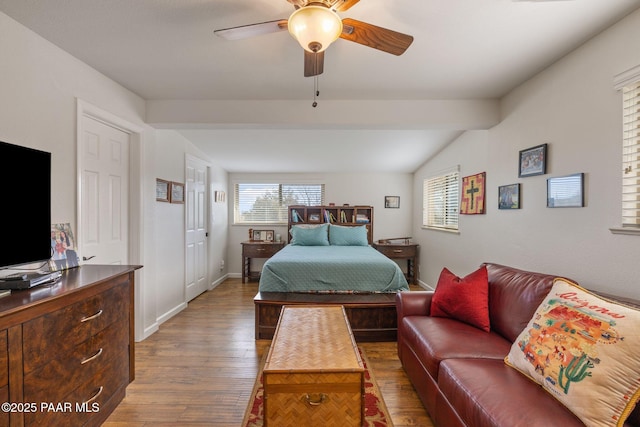 bedroom featuring baseboards, ceiling fan, vaulted ceiling, and hardwood / wood-style flooring