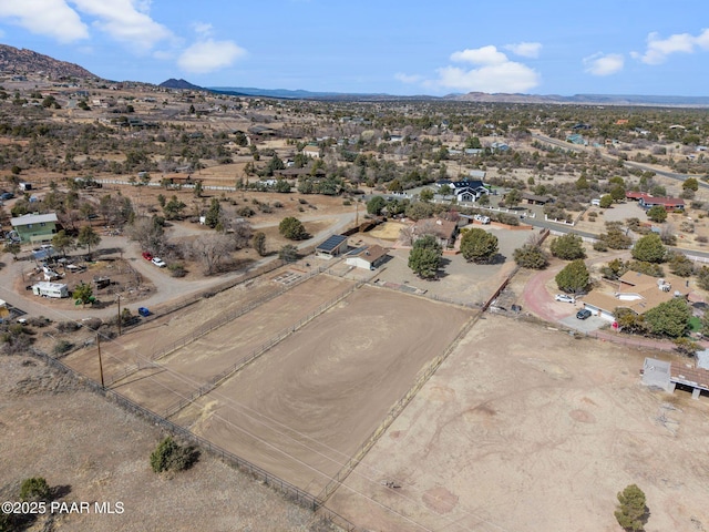 birds eye view of property featuring view of desert and a mountain view