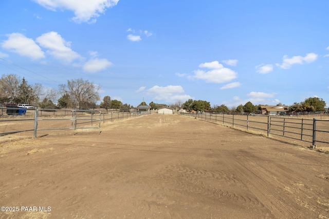 view of yard with an enclosed area and a rural view