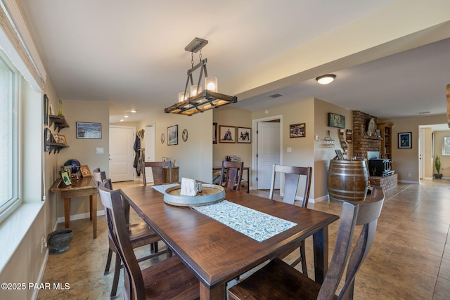 dining area featuring visible vents, baseboards, and a fireplace