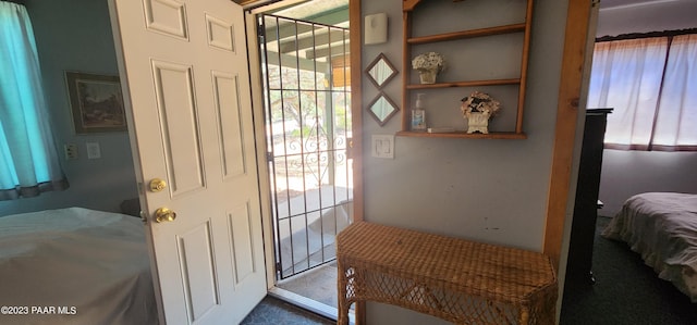 doorway to outside with carpet flooring