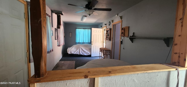 bedroom with dark colored carpet and ceiling fan