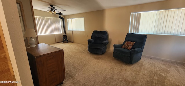 sitting room featuring light colored carpet and ceiling fan