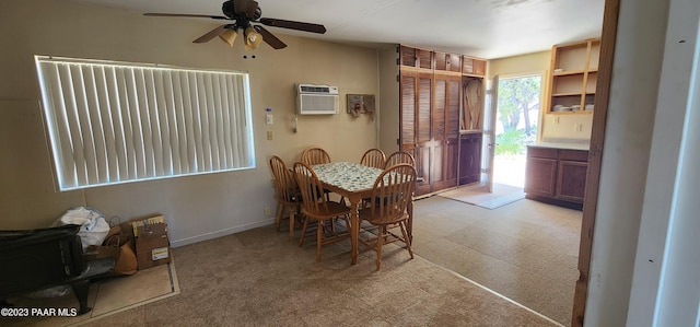 dining area featuring light carpet, a wall unit AC, and ceiling fan