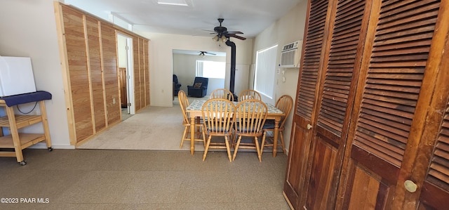 carpeted dining space featuring an AC wall unit and ceiling fan