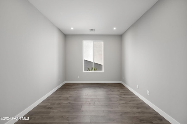 unfurnished room with dark hardwood / wood-style flooring