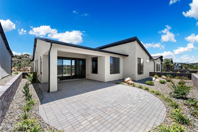 back of house with a patio area