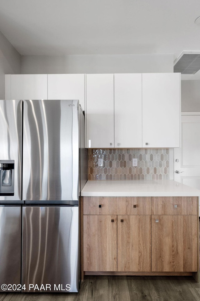 kitchen with white cabinets, stainless steel fridge, and dark hardwood / wood-style flooring