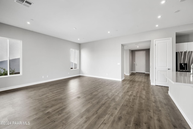 unfurnished living room featuring dark hardwood / wood-style flooring