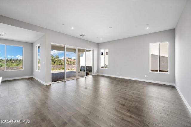 spare room with dark wood-type flooring