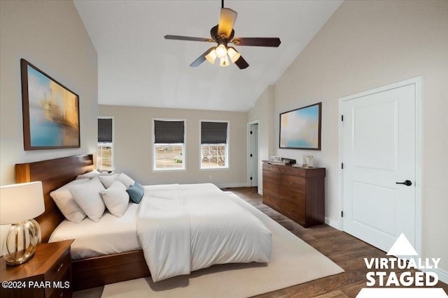 bedroom featuring dark wood-type flooring, high vaulted ceiling, and ceiling fan