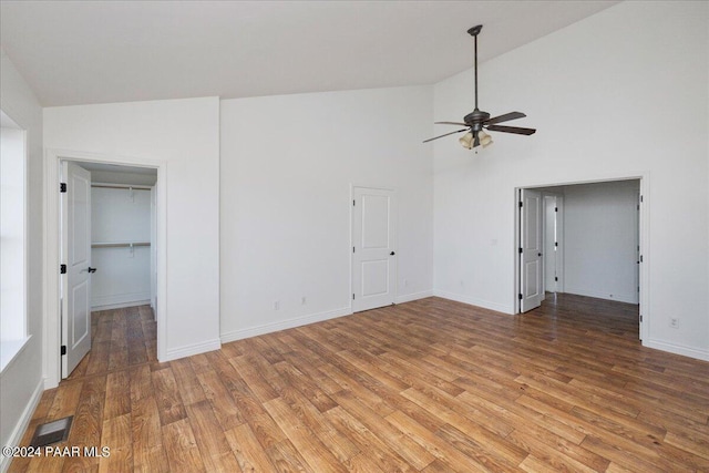 interior space with ceiling fan, high vaulted ceiling, and light hardwood / wood-style flooring