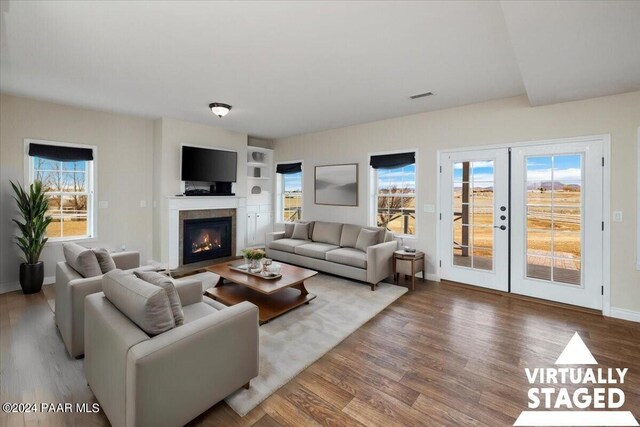 unfurnished living room with dark wood-type flooring and french doors