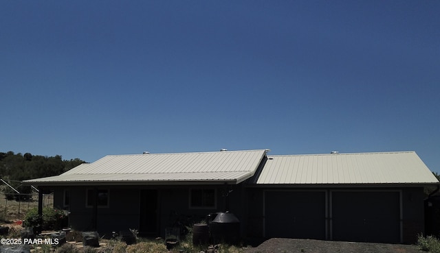 1155 W Half Moon Ct, Ash Fork, AZ 86320 - view of front of house with metal roof, a garage, and driveway