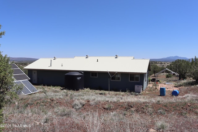 1155 W Half Moon Ct, Ash Fork, AZ 86320 - rear view of property with solar panels, metal roof, and a mountain view