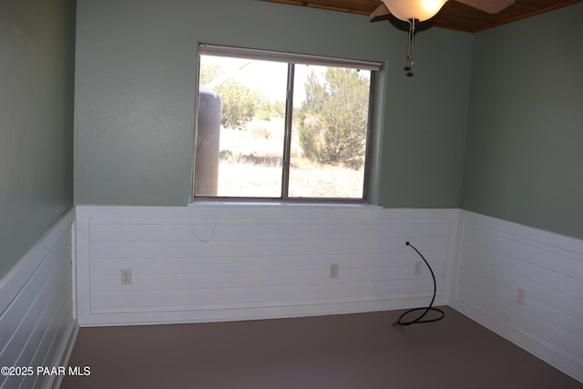 1155 W Half Moon Ct, Ash Fork, AZ 86320 - unfurnished room featuring a wainscoted wall, plenty of natural light, and ceiling fan