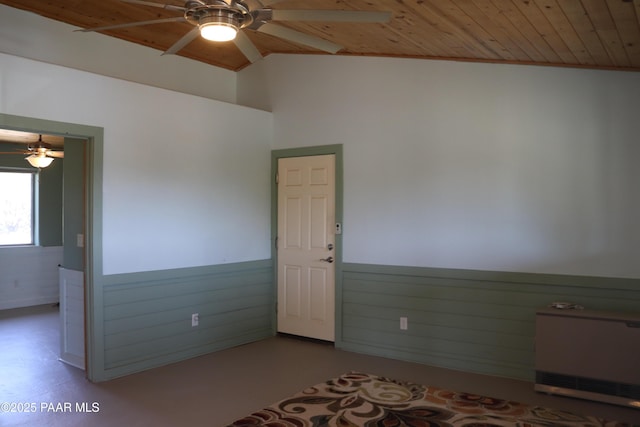 1155 W Half Moon Ct, Ash Fork, AZ 86320 - empty room with wooden ceiling, a ceiling fan, wainscoting, lofted ceiling, and wood walls